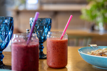 Berry and fruit smoothies in glass cups. Summer cafe. Soft focus