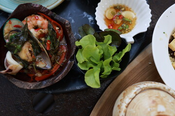 Thai food on a wooden table with copy space. Table food served on the table tradition Thai food delicious with fresh vegetables, Many varieties various Thai menus on plates and wooden tables, Asian fo