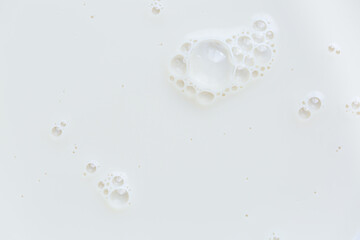 Macro milk surface close-up,Macro milk texture,White surface of milk and bubbles and ripples from above birds eye view
