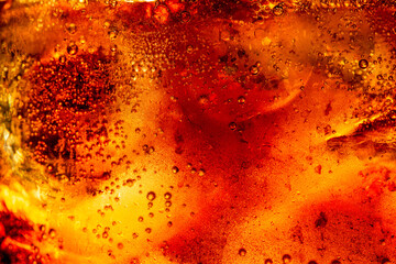 Macro cola and ice texture,Background of cola with ice and bubbles