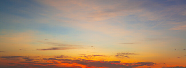 Clouds and sky in the evening,Real majestic sunrise sundown sky background with gentle colorful clouds without birds. Panoramic, big size