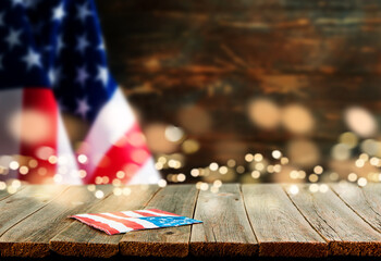 4th of July Independence Day background. Empty wooden plank table with American USA flag and...