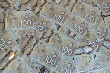 Canadian dollar bills spread on the table. 