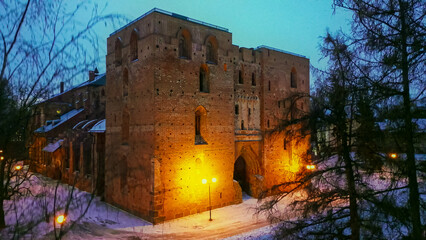 It is winter in Tartu Estonia, the park is covered with snow and we see the ruins of an ancient medieval church Tartu Toomkirik in the night