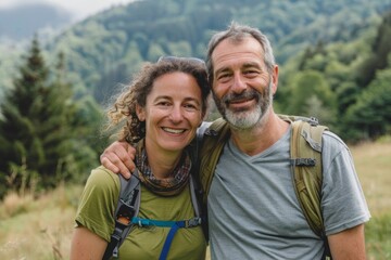 Portrait of a smiling caucasian couple in their 40s sporting a breathable hiking shirt on quiet countryside landscape