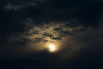Sunset against the backdrop of dark rain clouds.