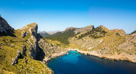 Panoramic  view of Cala Figuera little beach surrounded by mountains, Cap de Formentor cape, Majorca, Balearic Islands, Spain