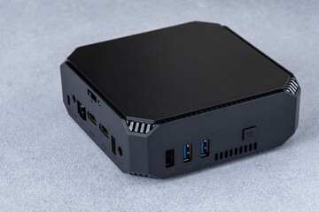 A small system unit of a personal computer. Compact black device.