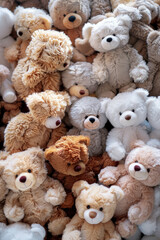 A tightly packed collection of small teddy bears in various colors and poses, filling the entire frame. The bears come in shades of brown, white, and pastel colors.