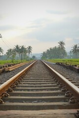 Railway tracks in rice fields. Beautiful views of rural Indonesia