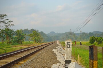 Railway tracks in rice fields. Beautiful views of rural Indonesia