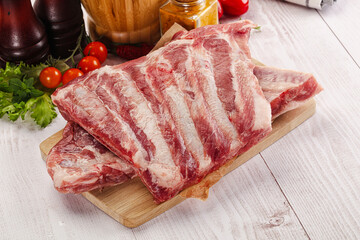 Raw pork ribs over board