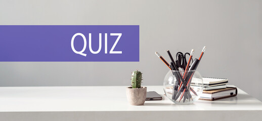 Desk Setup With Quiz Sign, Stationery, and Books Ready for Study Session