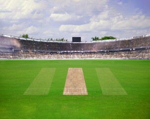 A cricket pitch direct top view of the layout with the grass cricket field. The pitch is inside the field and green field, Cricket match between two teams. © Belal