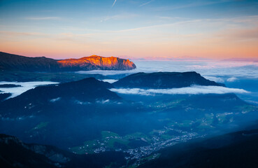 Morning view from Seceda Peak to the mountain ranges in the fog. Dolomite alps, National Park Gardena, Italy, Europe.