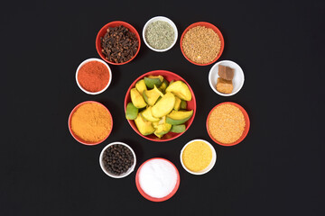 slices of mongo with different type of spices filled in bowls in circular shape