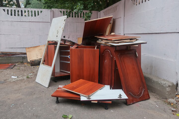 a set of modular kitchen furniture thrown in the trash