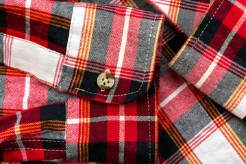 Men's shirt. Plaid shirt sleeve with buttons. Piece of clothing. Button