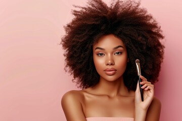 Obraz premium Beautiful young dark-skinned model applying makeup with brush