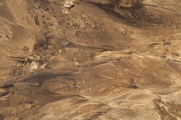  Background close-up a sandy surface.   Soil is washed away by the rain