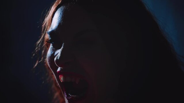 art portrait mouth close-up fantasy vampire person screams growls hisses shows sharp white teeth fangs lips beauty part face gothic woman in moon light night smoke fog dark room sexy girl werewolf 4k