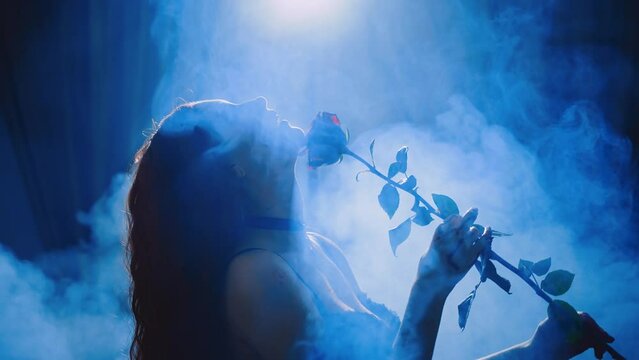 dark shadow silhouette fantasy woman holding red rose flower touching stroking neck skin seductive body lingerie. sexy girl black lace underwear. night moon light room full smoke magic fog art 4k