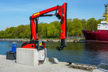 Port infrastructure element, a small hydraulic loader crane for lifting cargo from fishing vessels