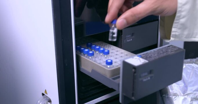 HPLC machine vials filling in HPLC machine. close up of science experiment. inside view in a Science experimental laboratory for research development in laboratory. HPLC machine filling vials.