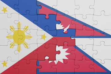 puzzle with the colourful national flag of nepal and flag of philippines.