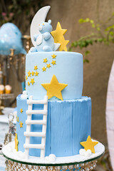 Delightful baby shower cake adorned with moon, stars, and an adorable blue elephant