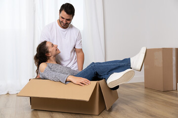 Happy couple packing their stuff to move into their new owned house. They are homeowners, mortgage concept. New home, new life