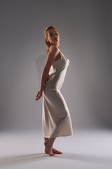 Fototapeta premium Young elegance woman in white dress in the darkness