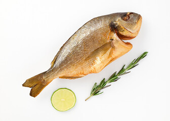 Smoked dorado fish sea breath on isolated white background close up top view decorated lemon slices, sprig of fresh rosemary. Omega3. Mediterranean seafood concept. Healthy food concept