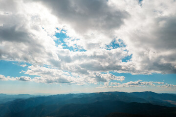 Fototapeta premium Moving white clouds blue sky scenic aerial view through summer. Drone slide turn flies forward high in blue sky through fluffy clouds on the panorama