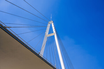 construction of a modern cable-stayed bridge on background of blue sky in Anhor Park in Tashkent in Uzbekistan. New pedestrian suspension bridge