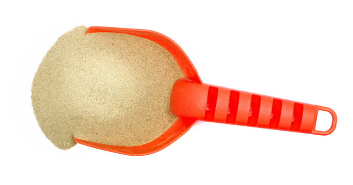 Red plastic shovel and sand, beach toy isolated on white, top view