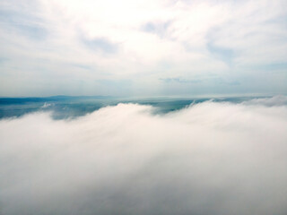 Beautiful nature white clouds Aerial view, blue sky horizon shooting from drone on sunny day high in the atmosphere front view