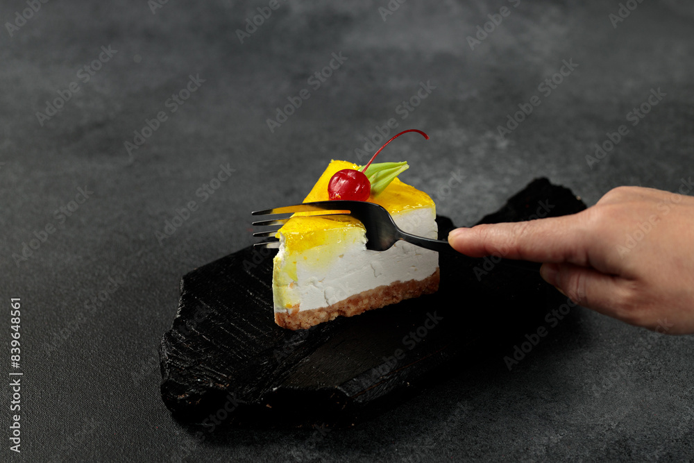 Wall mural lemon cheesecake with cherry. on a black background