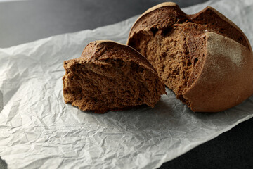 beautiful homemade raisin bread on parchment. Torn piece