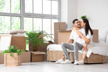 Young couple hugging in bedroom on moving day
