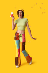 Teenage girl with soap bubble gun on yellow background