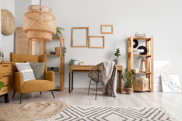 Interior of stylish living room with comfortable armchair, chest of drawers and cushions