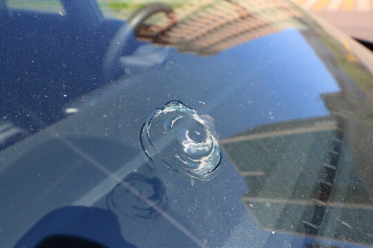 Car windshield with a chip in the middle