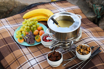 picnic on the beach with cheese fondue and fruit