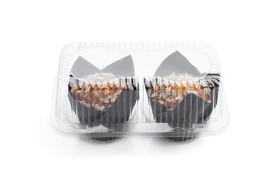 Homemade delicious wholegrain muffins in plastic pack isolated on white