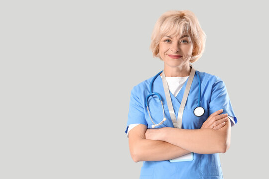 Female doctor on light background