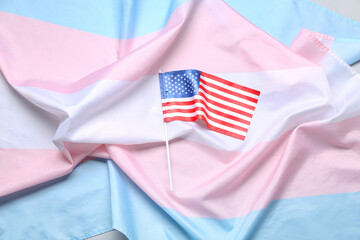 Transgender and USA flags on grey background