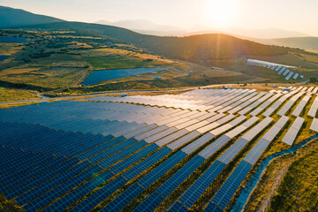 Solar farm with photovoltaic panels converting solar power to electricity for green energy