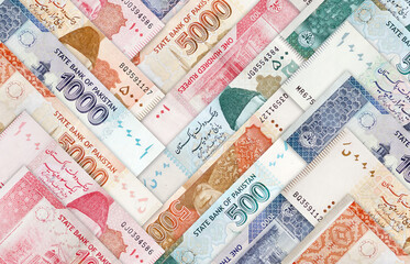 Multiple Pakistani Currency Bank notes arranged in an angular pattern