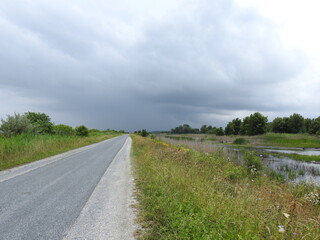 Fototapeta premium The ever changing beauty of the wetlands, as storm clouds fill the sky. Bombay Hook National Wildlife Refuge, Kent County, Delaware.